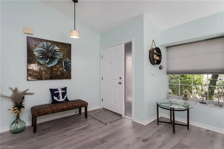 Foyer featuring wood finished floors and baseboards