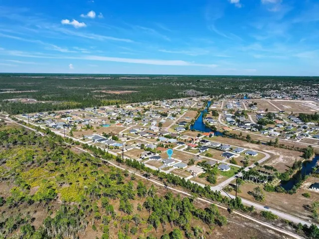 Aerial view of residential area featuring a large body of water