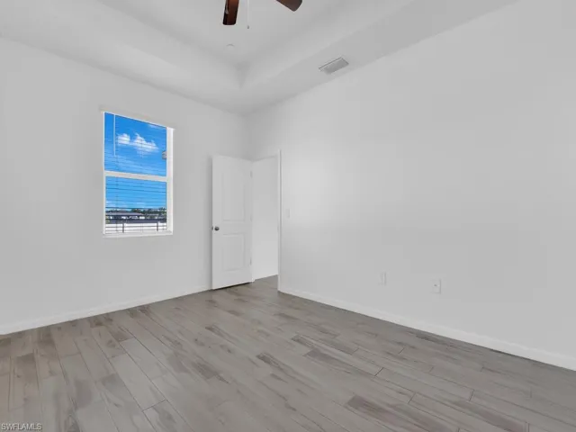 Unfurnished room featuring wood finished floors and ceiling fan