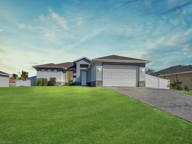 Prairie-style home with stone siding, decorative driveway, stucco siding, and an attached garage