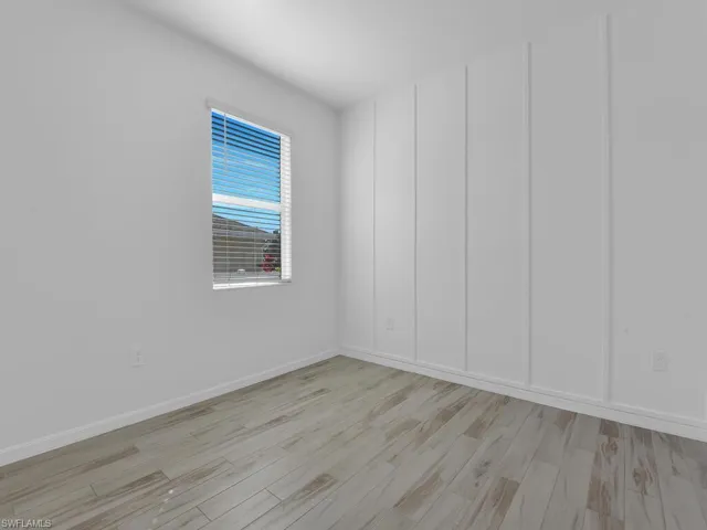 Spare room with light wood-style flooring and baseboards
