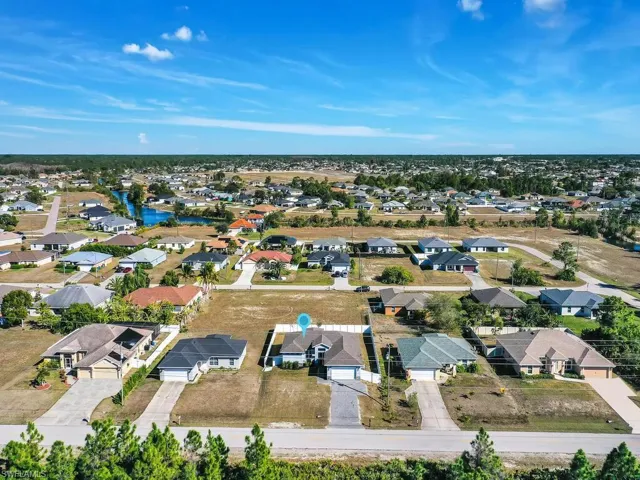 Aerial perspective of suburban area featuring a nearby body of water