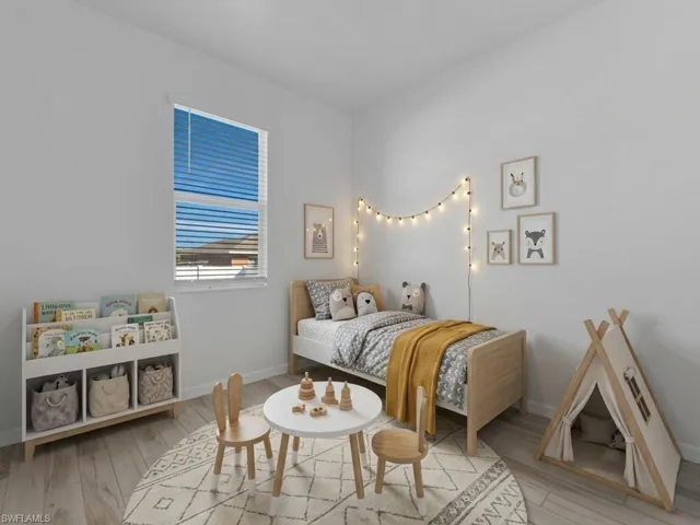 Bedroom featuring light wood-type flooring and baseboards