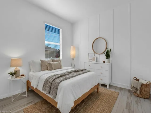 Bedroom featuring light wood-style flooring and baseboards