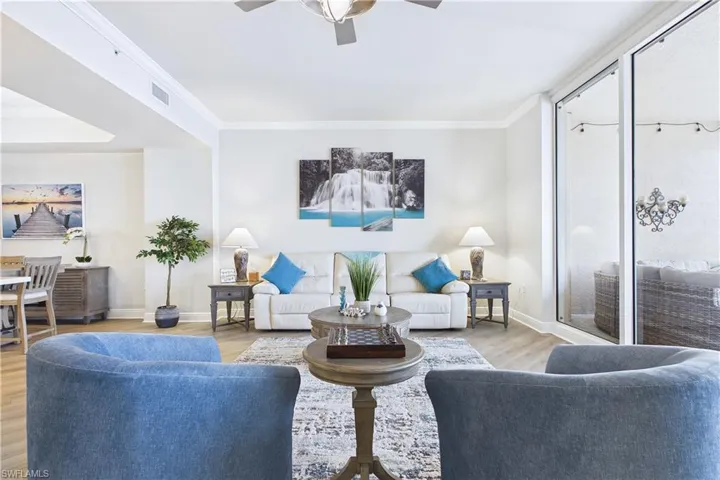 Living area featuring ceiling fan, crown molding, and wood finished floors