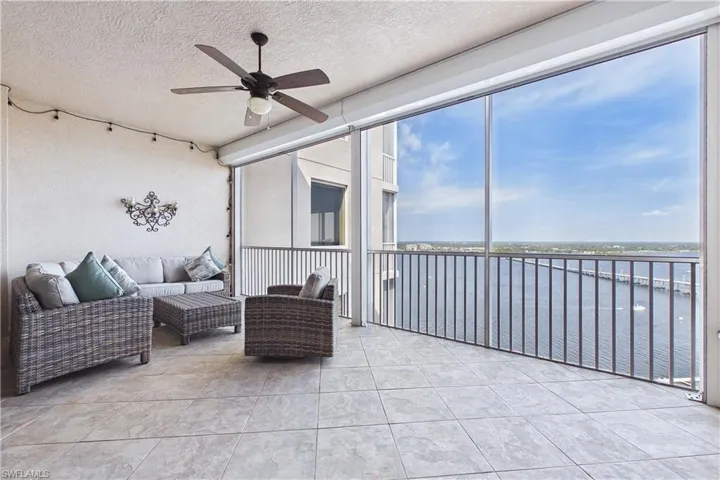 Sunroom / solarium with ceiling fan, plenty of natural light, and an outdoor hangout area