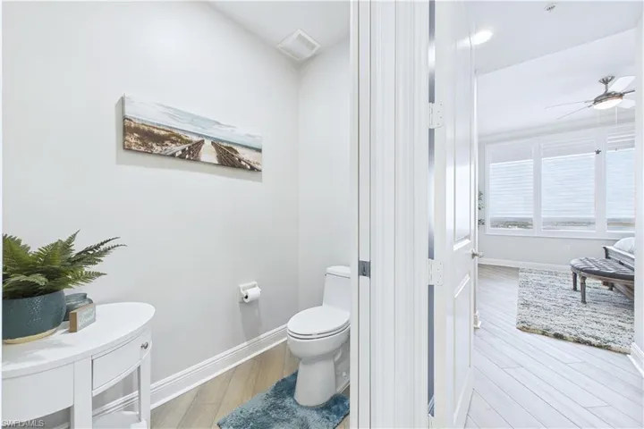 Bathroom featuring light wood-type flooring and ceiling fan