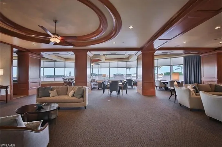 Community lobby featuring a decorative wall, recessed lighting, and a tray ceiling