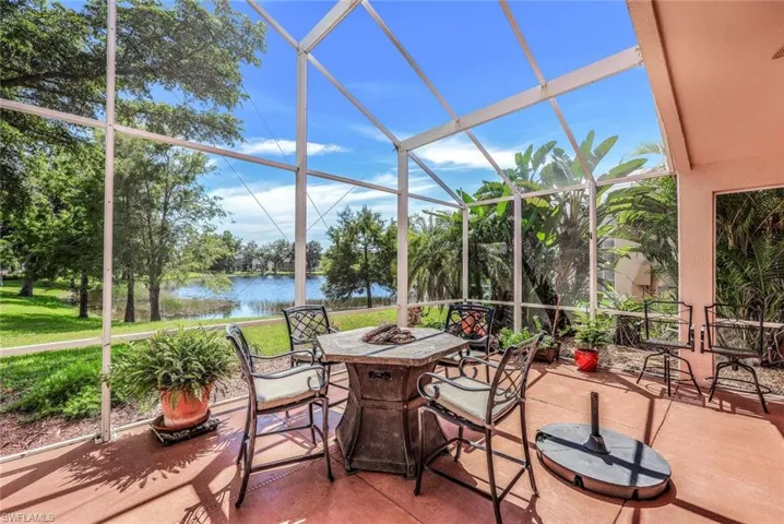 Sunroom featuring a water view