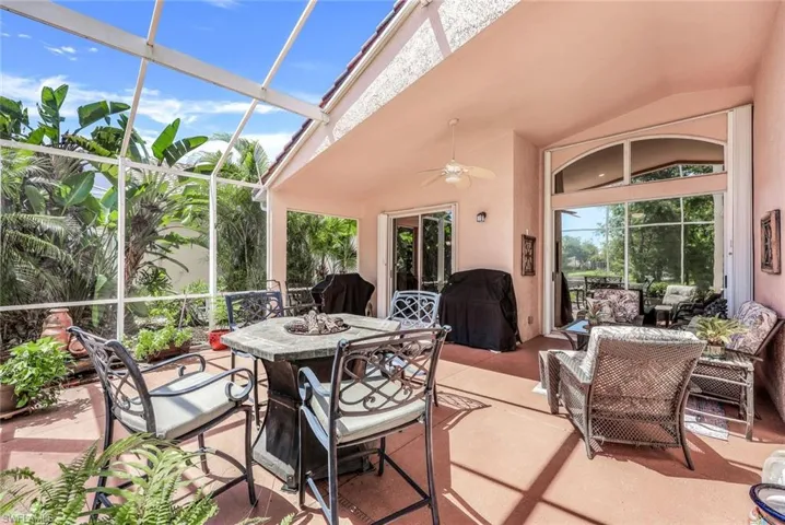 Sunroom featuring lofted ceiling, plenty of natural light, and ceiling fan