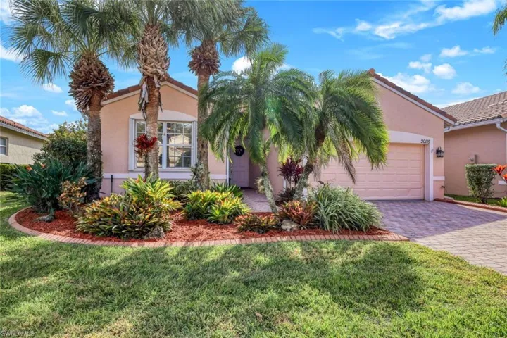 View of front of home with a garage and a front lawn