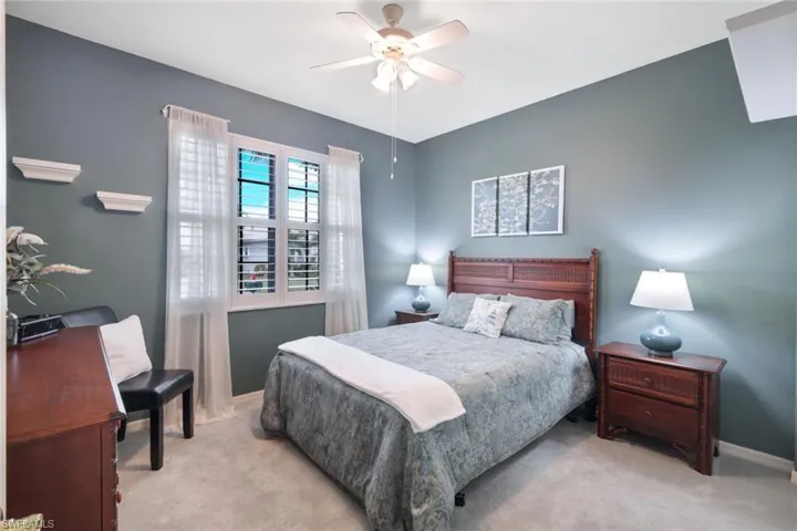 Bedroom featuring light colored carpet and ceiling fan