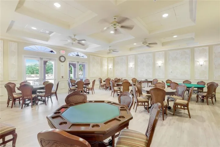Dining room featuring light wood-type flooring, french doors, coffered ceiling, and ceiling fan