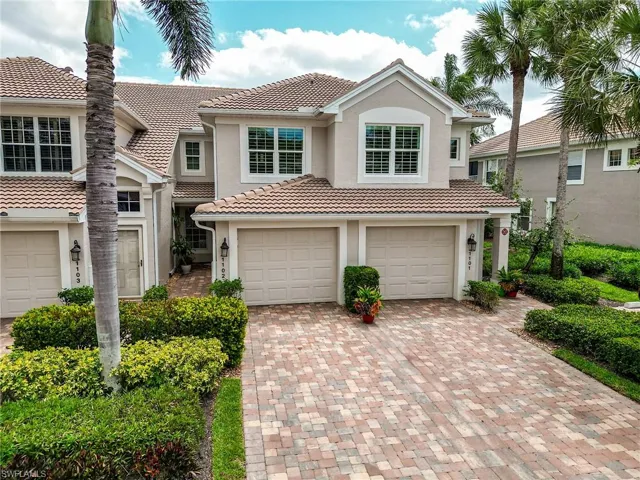 View of front of house with stucco siding, an attached garage, a tile roof, and decorative driveway