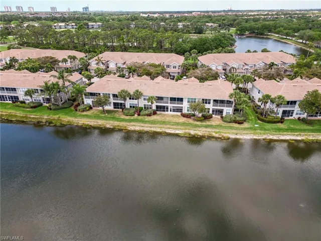 Drone / aerial view with a residential view and a water view