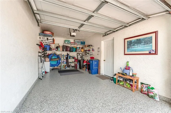 Garage featuring a textured wall and a garage door opener