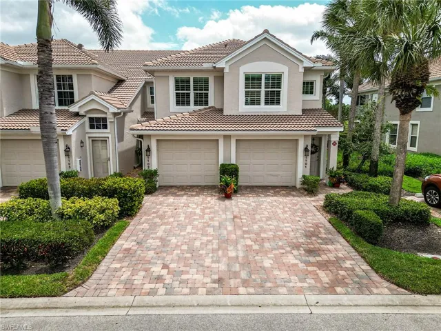 Mediterranean / spanish-style home featuring stucco siding, a garage, a tiled roof, and decorative driveway