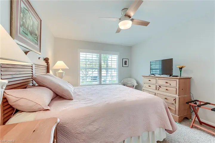 Bedroom featuring light colored carpet and a ceiling fan