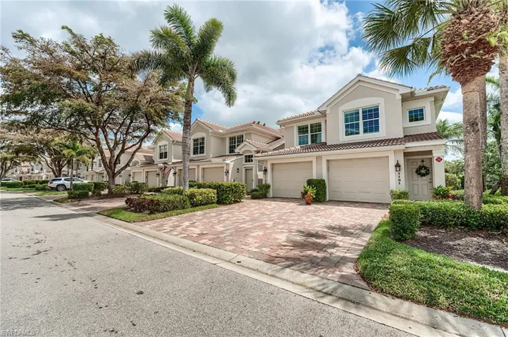 View of front of house featuring driveway, stucco siding, a garage, and a tiled roof