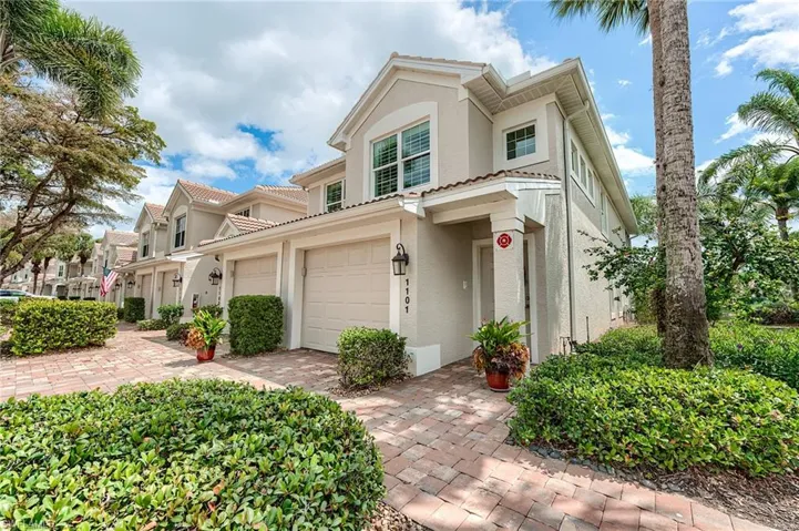 Mediterranean / spanish house with a tiled roof, a garage, decorative driveway, and stucco siding