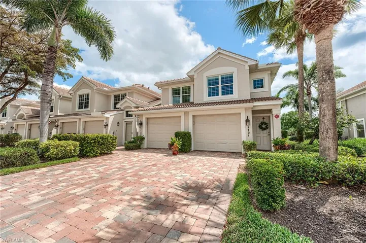 Mediterranean / spanish home with stucco siding, an attached garage, a tile roof, and decorative driveway
