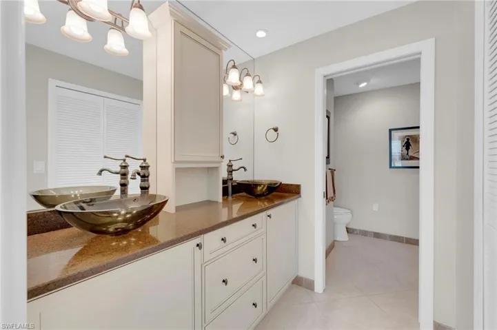 Bathroom with double vessel sinks and ample storage