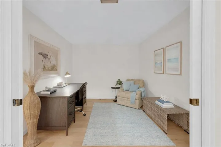 Partially virtually staged, den or office space with pocket doors