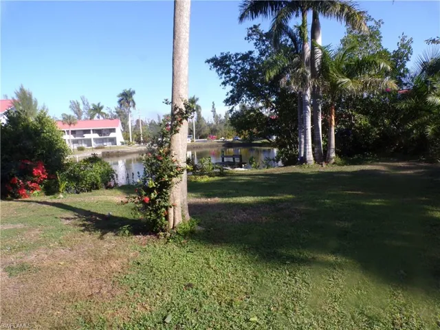 View of green lawn featuring a water view