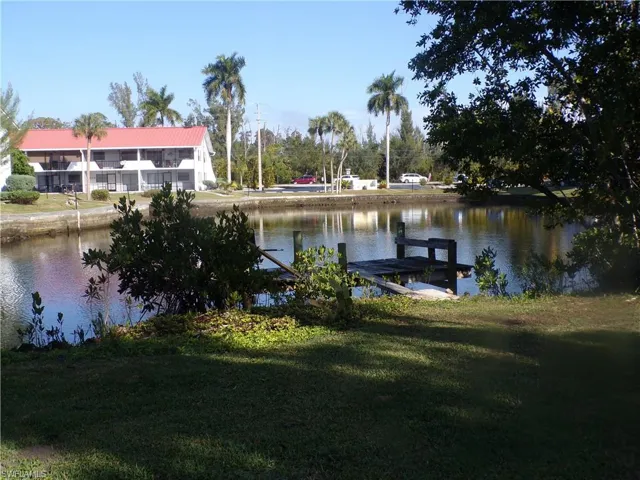 Dock featuring a water view and a lawn