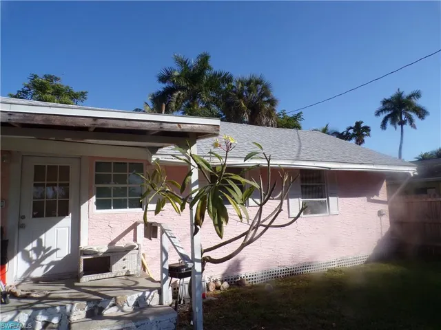 View of side of home featuring stucco siding