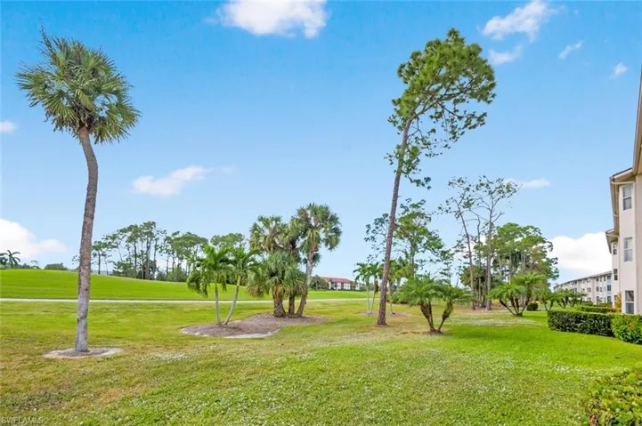 View of home's community with a yard