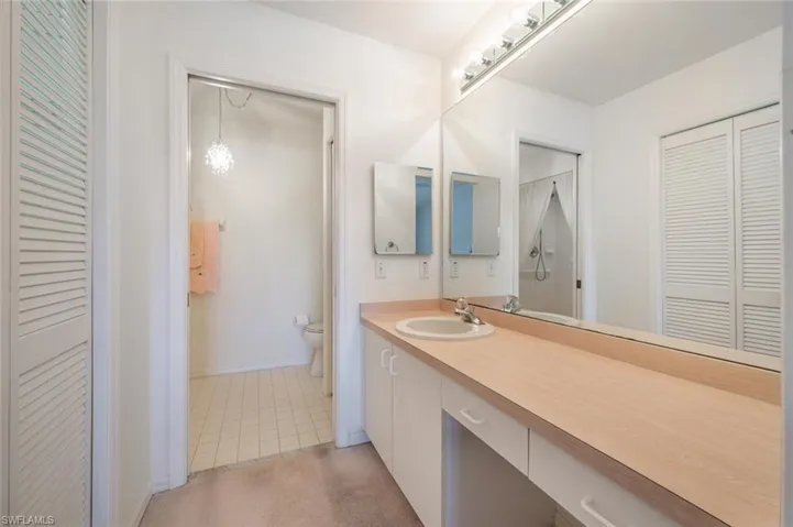 Bathroom with tile patterned floors, vanity, and toilet