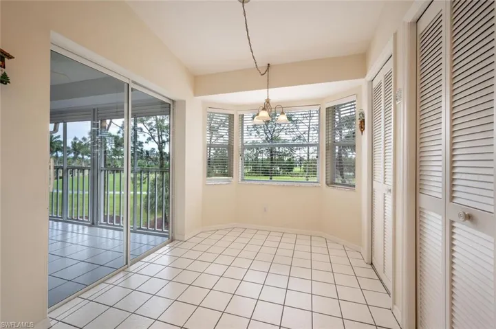 Unfurnished sunroom featuring a notable chandelier