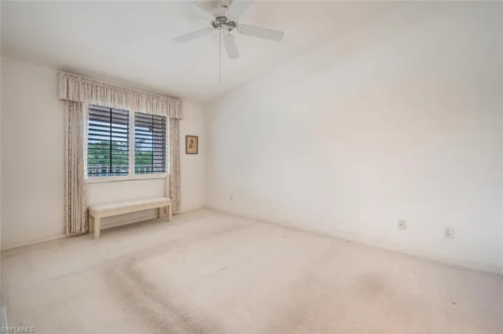 Empty room featuring carpet flooring and ceiling fan