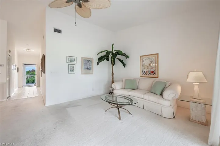 Living room featuring ceiling fan and light colored carpet