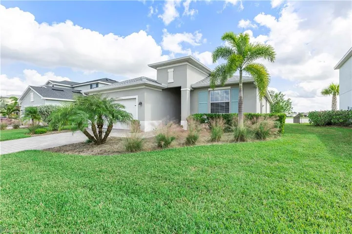 View of front of home featuring a garage and a front lawn