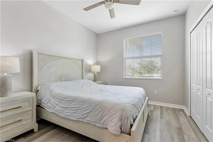 Guest Bedroom with ceiling fan, closet, and light hardwood / wood-style flooring