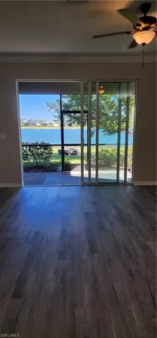 Wow! What a water view, crown molding, and hardwood / wood-style floors