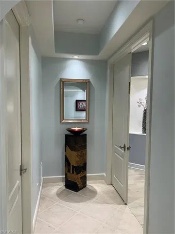 Corridor featuring recessed lighting and light tile patterned flooring