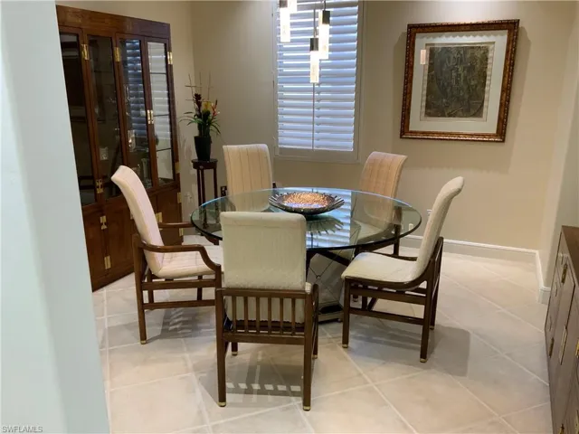 Dining room featuring light tile patterned floors and baseboards