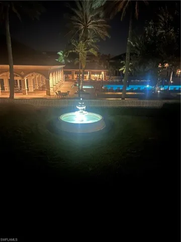 View of fountain and pool at night from lanai.