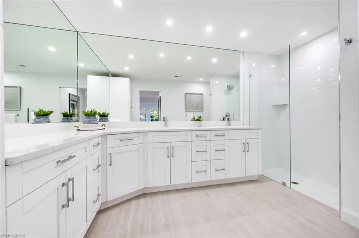 Full bath featuring double vanity, walk in shower, recessed lighting, and wood tiled floors