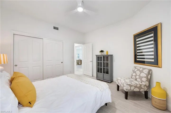 Bedroom with ceiling fan and a closet