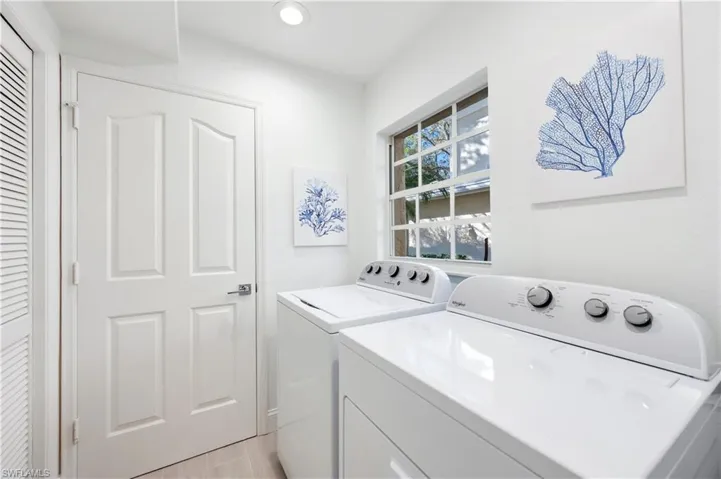 Laundry area with washing machine and dryer and recessed lighting