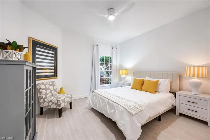 Bedroom featuring wood tiled floors and a ceiling fan