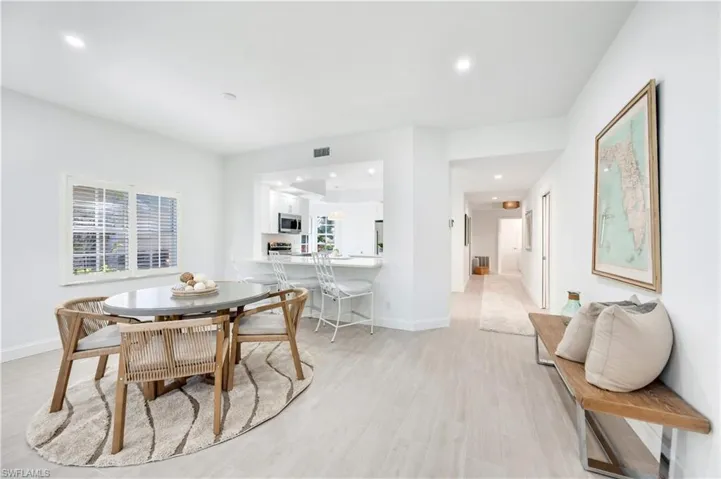 Dining space featuring light wood-style floors, recessed lighting, and healthy amount of natural light