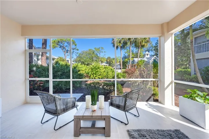 Sunroom / solarium with wood finished floors and a textured wall