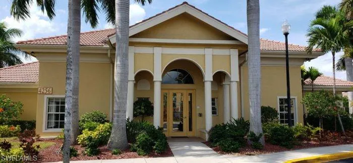 Entrance to property featuring stucco siding, a tiled roof, and french doors