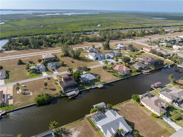 Aerial overview of property's location with a nearby body of water and nearby suburban area