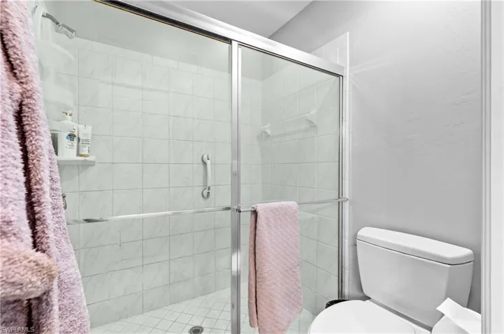 Bathroom with toilet and a stall shower